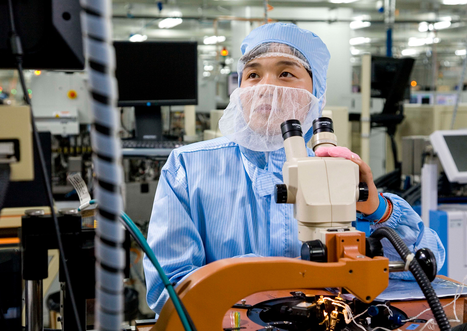 technician using binocular microscope | best corporate photography in China