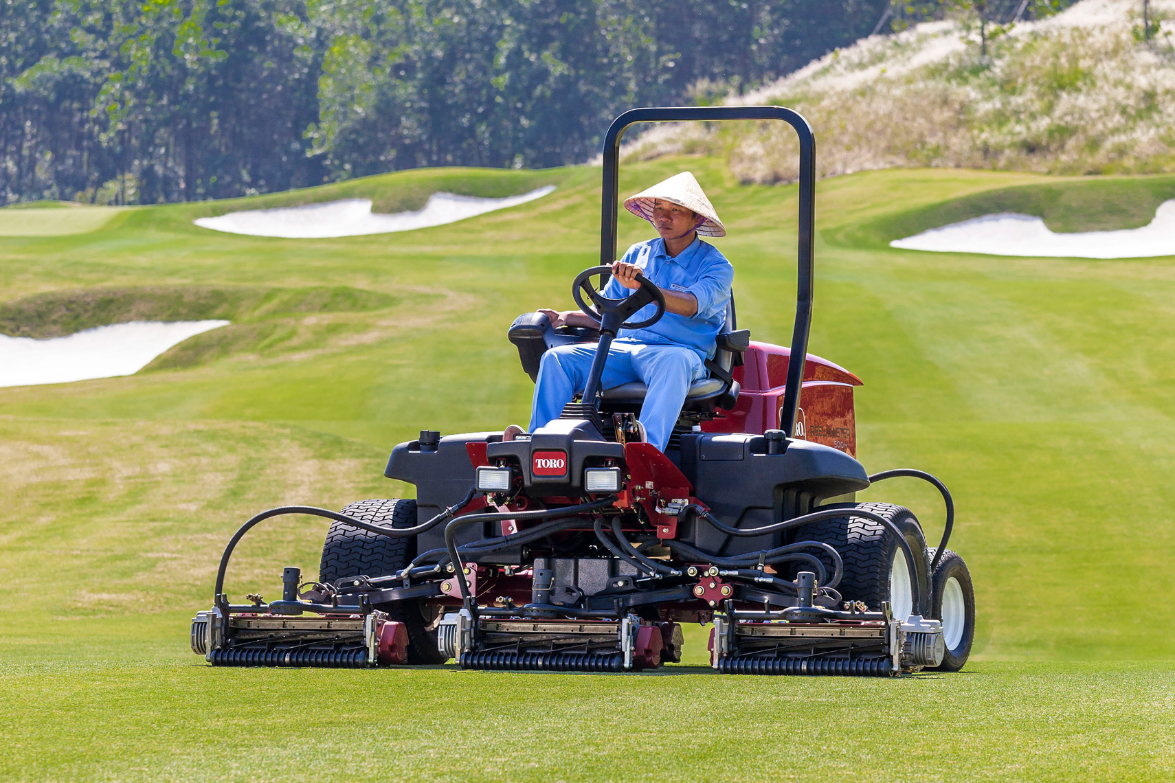 groundskeeper at golf course in Vietnam best Asia commercial photography